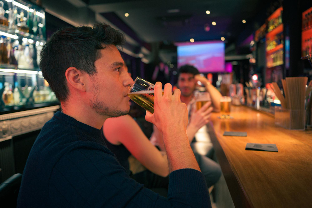 A happy customer in a bar where skill based gaming