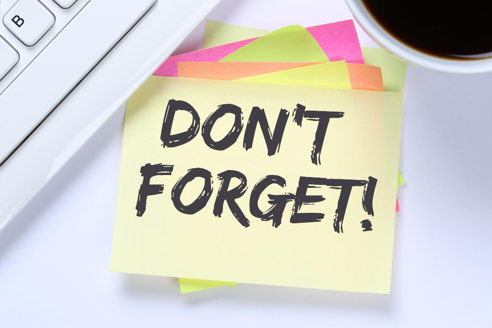 Sticky note that says “Don’t forget!” on a desk, reminding owners to drop burnout-causing tasks.