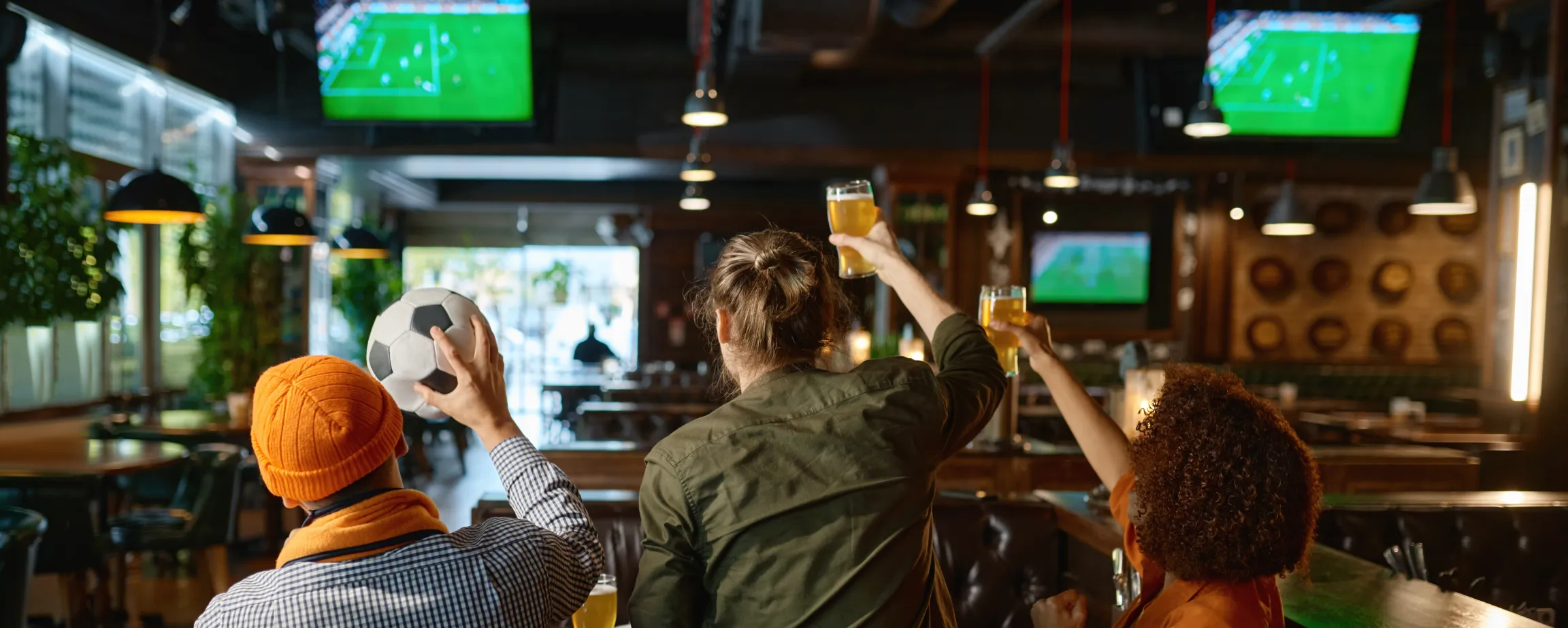 A group of regulars enjoying a game together, demonstrating how shared bar entertainment ideas create a community and keep guests coming back.